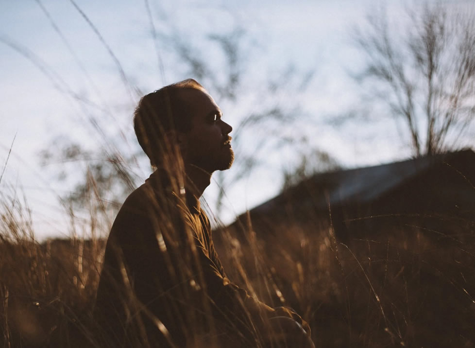 Man meditating in a field